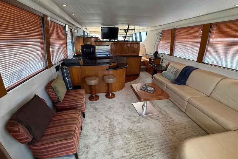  Yacht Photos Pics Luxurious interior of 2002 Carver 570 Voyager Pilothouse with modern furnishings and wood accents.