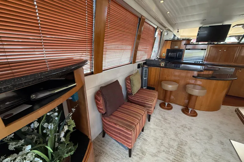 Yacht Photos Pics Luxurious interior of 2002 Carver 570 Voyager Pilothouse with seating, kitchen, and decor.