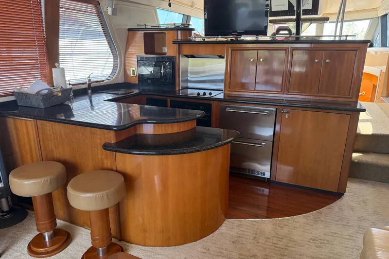  Yacht Photos Pics Luxurious kitchen interior of 2002 Carver 570 Voyager Pilothouse yacht with wood cabinetry.