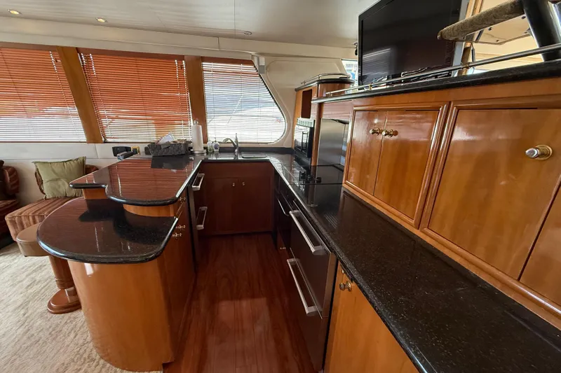  Yacht Photos Pics Luxurious kitchen interior of 2002 Carver 570 Voyager Pilothouse yacht with wood cabinetry.