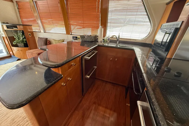  Yacht Photos Pics Luxurious kitchen interior of 2002 Carver 570 Voyager Pilothouse yacht with wood cabinetry.