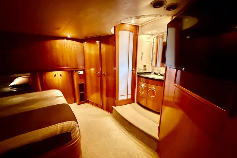  Yacht Photos Pics Luxurious interior of 2002 Carver 570 Voyager Pilothouse with wood finishes and elegant bathroom.
