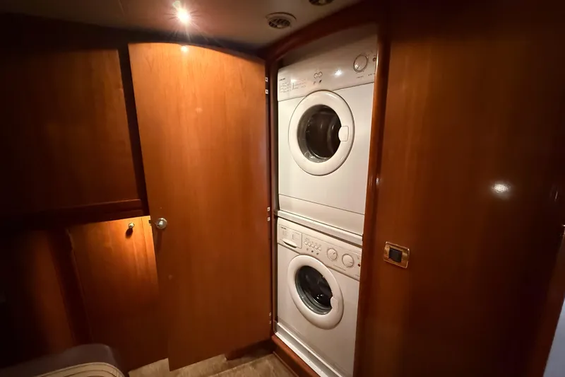  Yacht Photos Pics Stacked washer and dryer in 2002 Carver 570 Voyager Pilothouse laundry area.