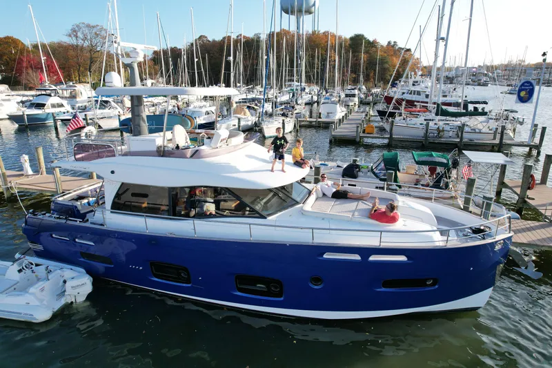 Sparrow Yacht Photos Pics 2014 Azimut Magellano 50 yacht docked in a marina, surrounded by other boats.