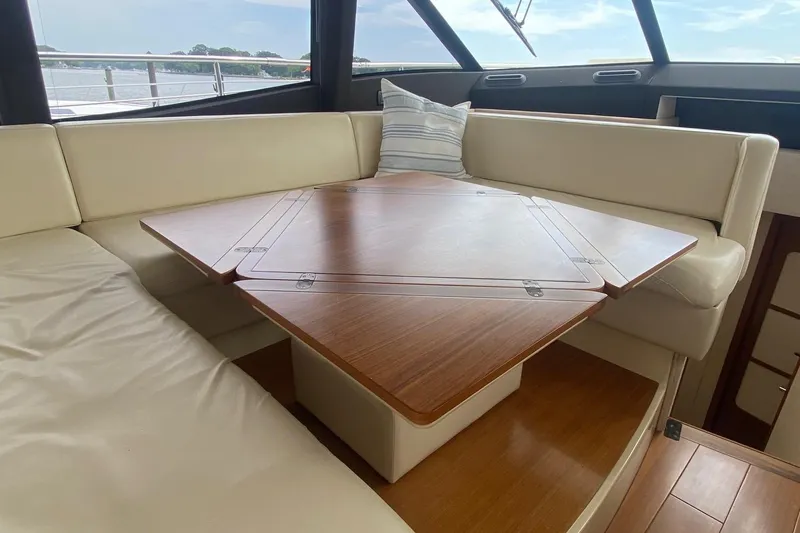 Sparrow Yacht Photos Pics Luxurious interior of 2014 Azimut Magellano 50 yacht with elegant wooden table.