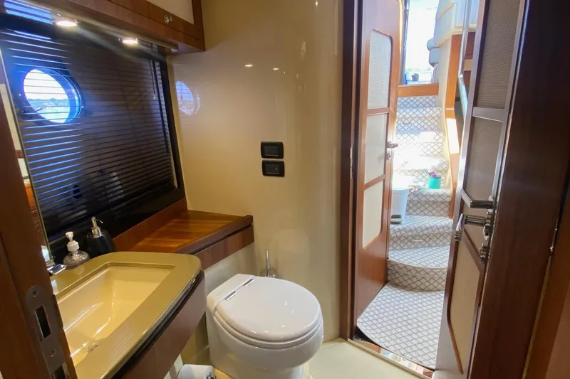 Sparrow Yacht Photos Pics Luxurious bathroom on 2014 Azimut Magellano 50 yacht with modern fixtures and wooden accents.