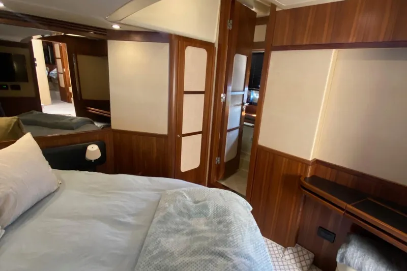 Sparrow Yacht Photos Pics Luxurious bedroom interior of 2014 Azimut Magellano 50 yacht with wood paneling and cozy bedding.