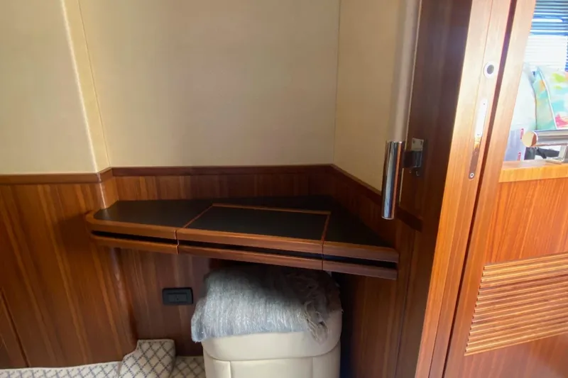 Sparrow Yacht Photos Pics Interior of 2014 Azimut Magellano 50 yacht with wooden paneling and compact desk.