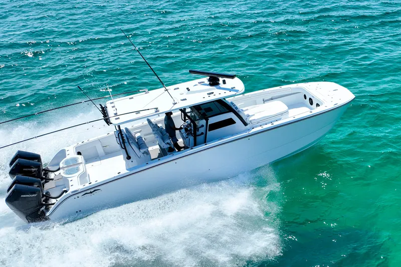  Yacht Photos Pics 2026 Invincible 40 Catamaran cruising on clear blue ocean waters.