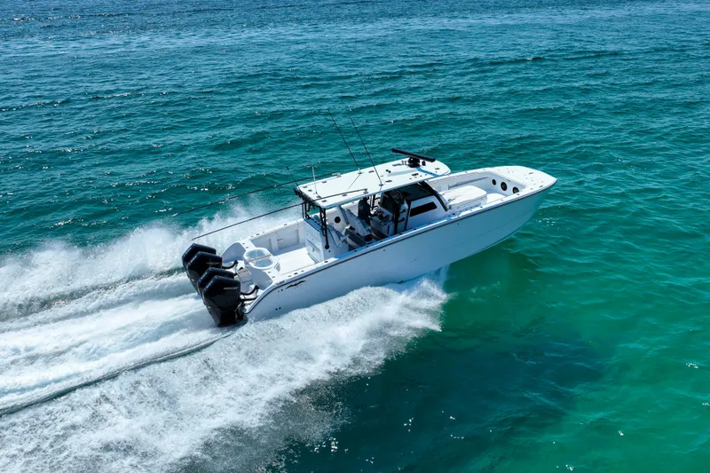  Yacht Photos Pics 2026 Invincible 40 Catamaran cruising on clear blue ocean waters.