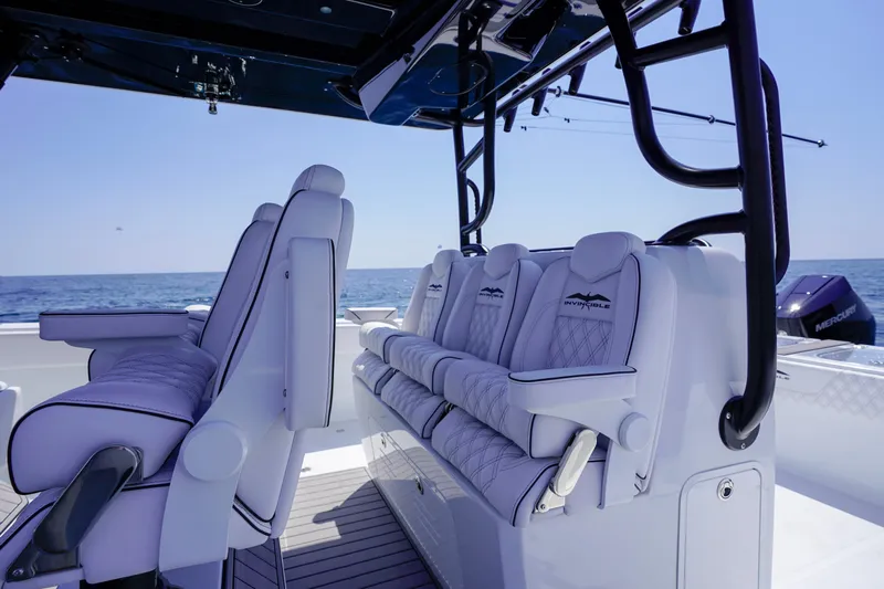  Yacht Photos Pics Luxurious seating on 2026 Invincible 40 Catamaran, featuring sleek design and ocean backdrop.