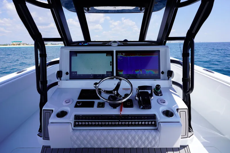 Yacht Photos Pics Helm of 2026 Invincible 40 Catamaran with advanced navigation displays and controls, on open sea.