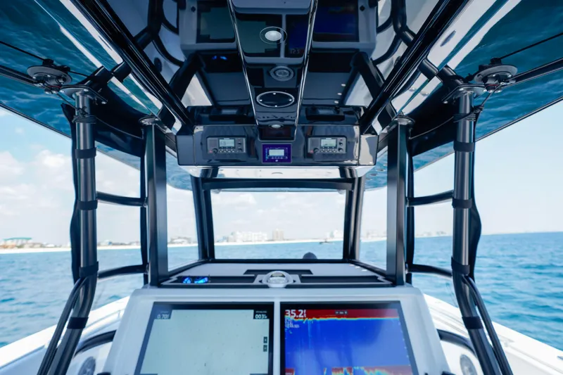  Yacht Photos Pics Interior view of 2026 Invincible 40 Catamaran cockpit with navigation screens and ocean backdrop.