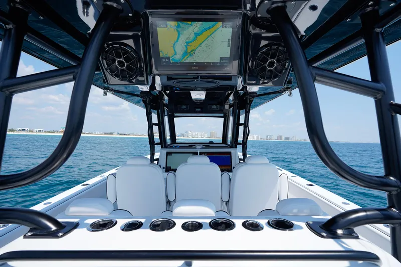  Yacht Photos Pics 2026 Invincible 40 Catamaran interior with navigation screens, ocean view, and white seating.