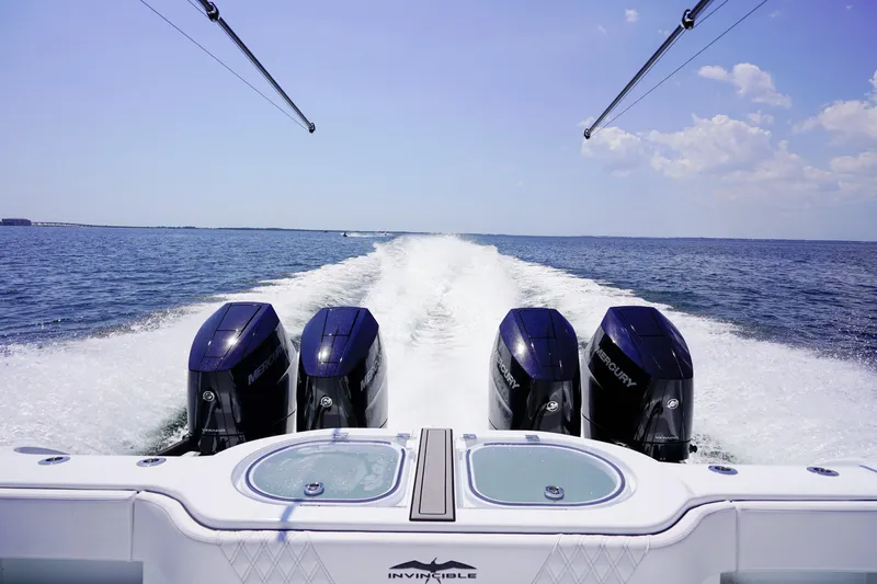  Yacht Photos Pics 2026 Invincible 40 Catamaran with four Mercury engines cruising on open water.