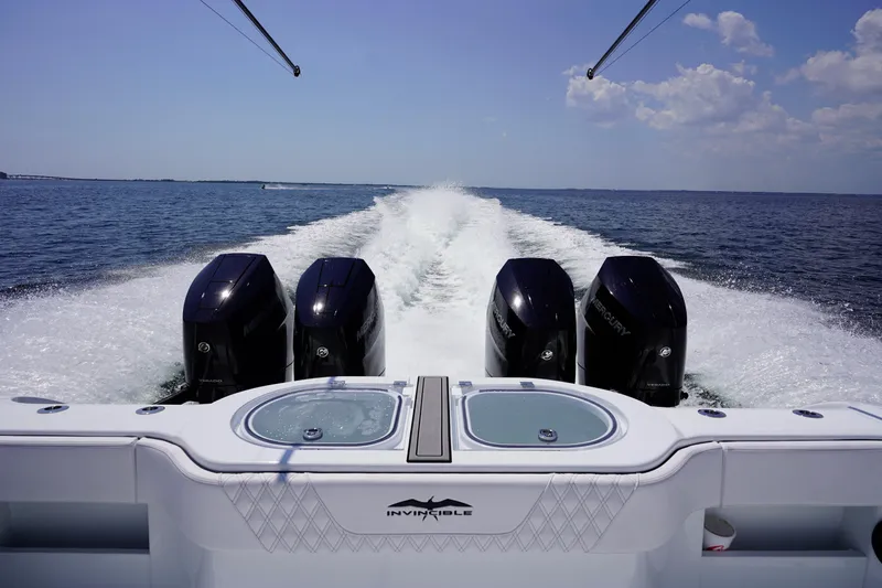  Yacht Photos Pics 2026 Invincible 40 Catamaran with four powerful outboard motors cruising on open water.