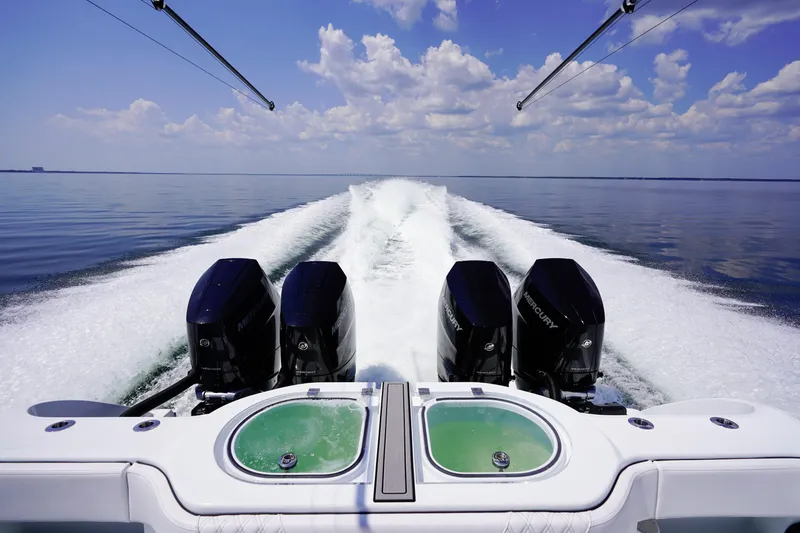  Yacht Photos Pics 2026 Invincible 40 Catamaran with powerful Mercury engines cruising on calm waters.