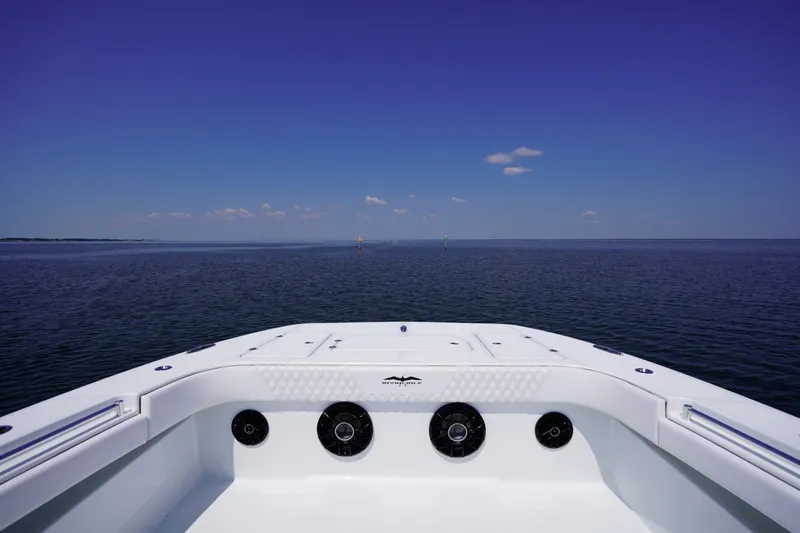  Yacht Photos Pics Bow view of 2026 Invincible 40 Catamaran on open sea under clear blue sky.