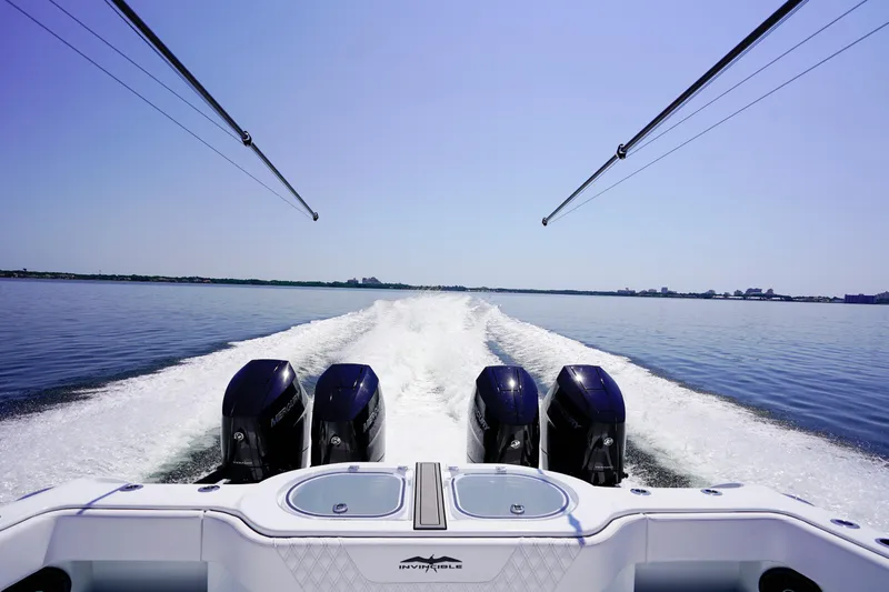  Yacht Photos Pics 2026 Invincible 40 Catamaran cruising on calm waters with powerful engines.