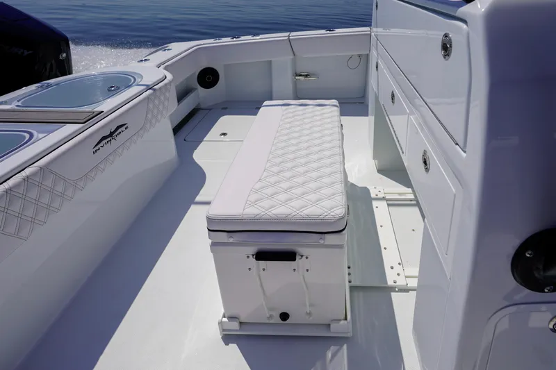  Yacht Photos Pics 2026 Invincible 40 Catamaran interior with cushioned seating and storage compartments.