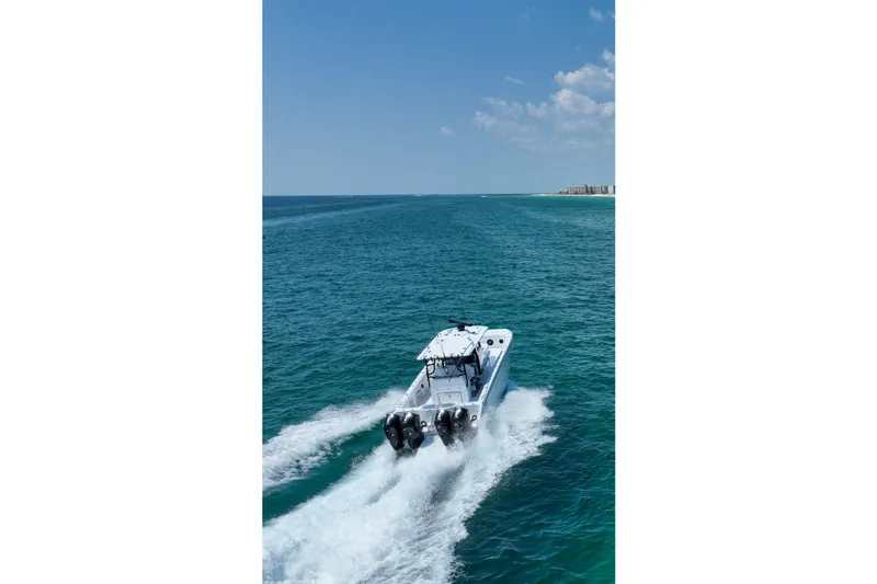  Yacht Photos Pics 2026 Invincible 40 Catamaran cruising on open blue ocean under clear sky.