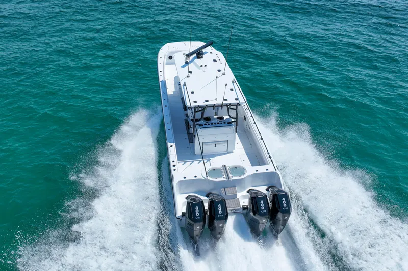  Yacht Photos Pics Invincible 40 Catamaran 2026 cruising on turquoise ocean waters, rear view.