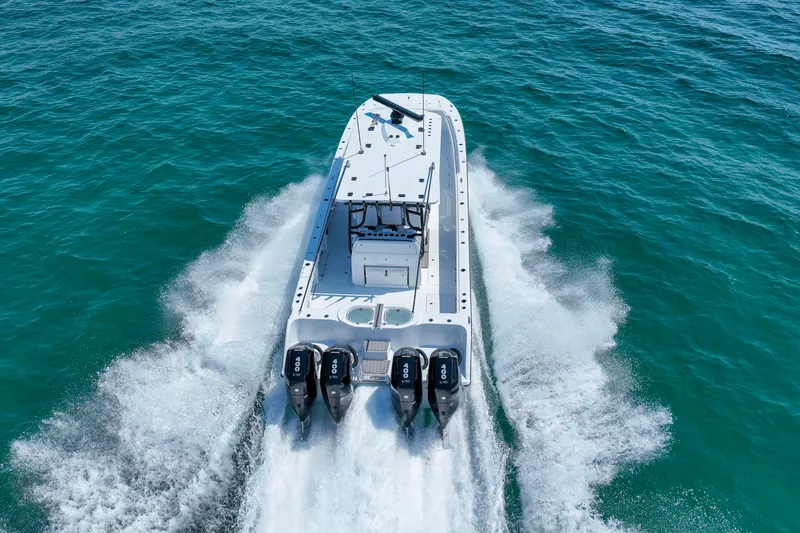  Yacht Photos Pics 2026 Invincible 40 Catamaran speeding on open water, showcasing powerful engines and sleek design.