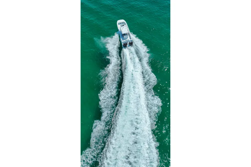  Yacht Photos Pics Aerial view of 2026 Invincible 40 Catamaran cruising on turquoise water.