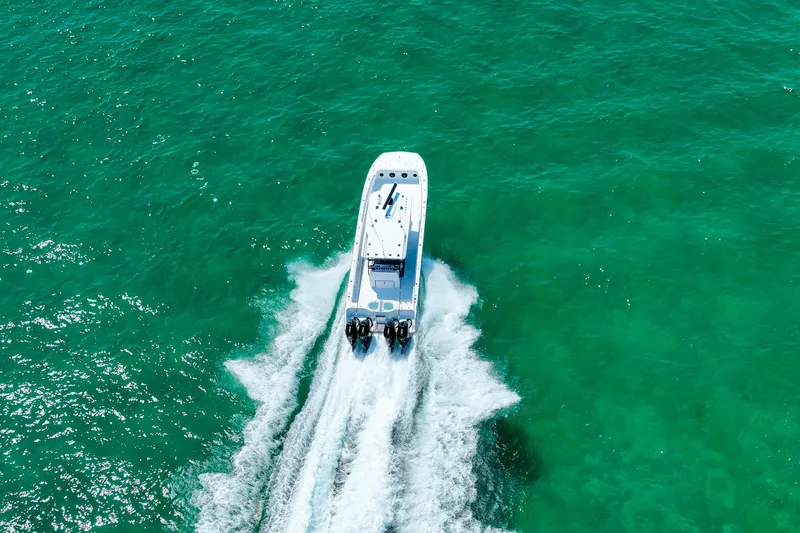  Yacht Photos Pics Aerial view of 2026 Invincible 40 Catamaran cruising on turquoise water.