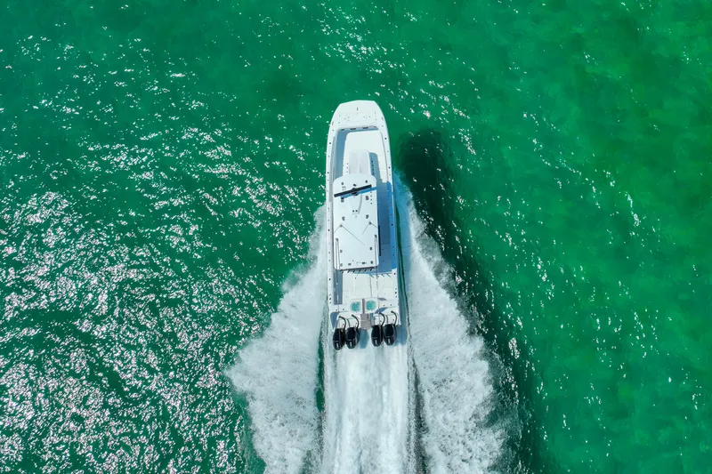  Yacht Photos Pics Aerial view of 2026 Invincible 40 Catamaran cruising on vibrant turquoise water.