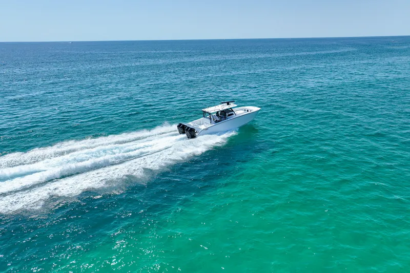  Yacht Photos Pics 2026 Invincible 40 Catamaran cruising on clear blue ocean waters.