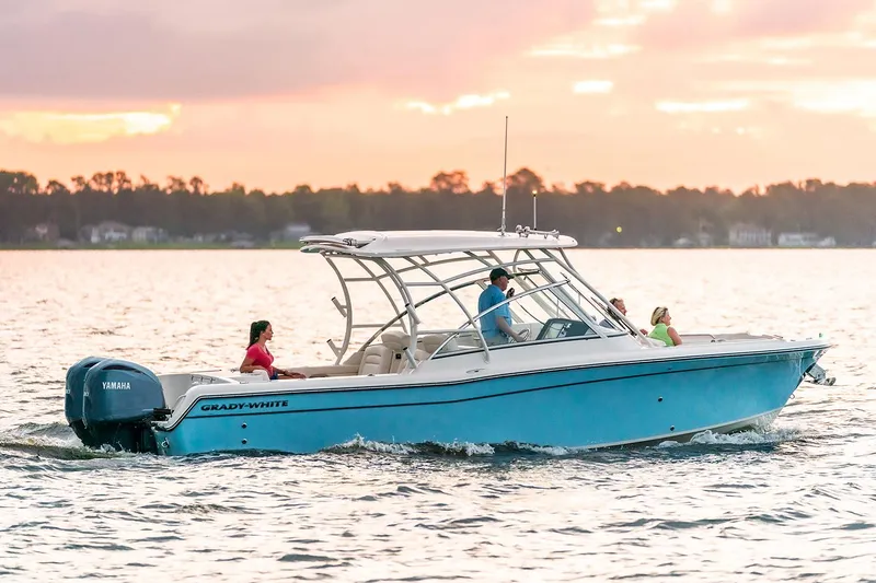  Yacht Photos Pics Manufacturer Provided Image: 2023 Grady-White Freedom 285 boat cruising on a lake at sunset.