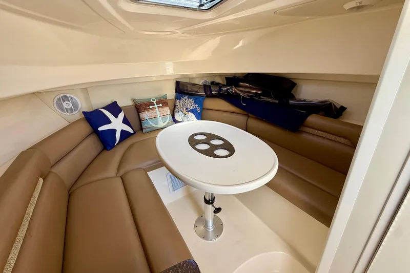  Yacht Photos Pics 2007 Boston Whaler 285 Conquest cabin interior with seating and nautical-themed cushions.