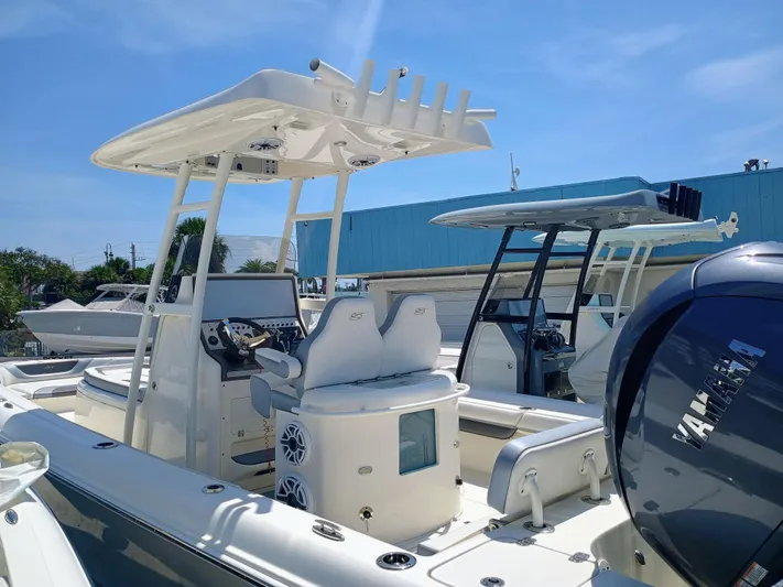 270-912 Yacht Photos Pics 2024 ShearWater 270 Carolina SS Open Bow boat with Yamaha engine, docked under clear sky.