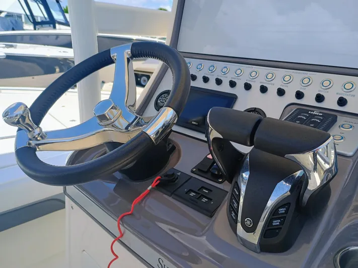 270-912 Yacht Photos Pics Steering console of 2024 ShearWater 270 Carolina SS Open Bow boat.