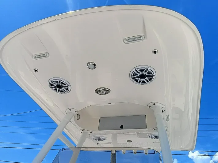 270-912 Yacht Photos Pics 2024 ShearWater 270 Carolina SS Open Bow boat canopy with speakers against blue sky.