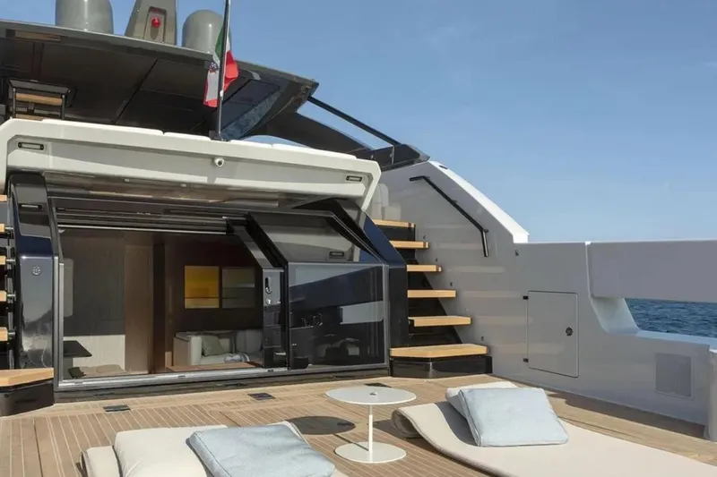  Yacht Photos Pics Luxurious 2025 Bluegame BG74 yacht deck with sun loungers and ocean view.