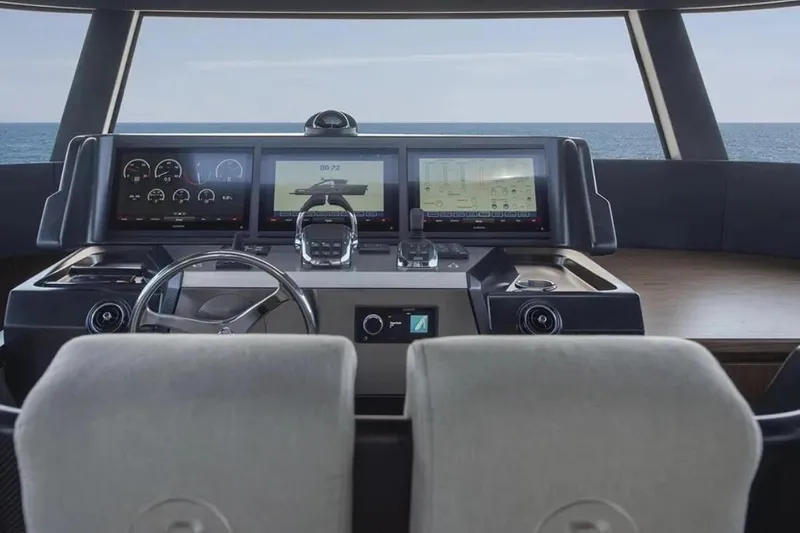  Yacht Photos Pics Helm of 2025 Bluegame BG74 yacht with modern navigation displays and steering wheel.