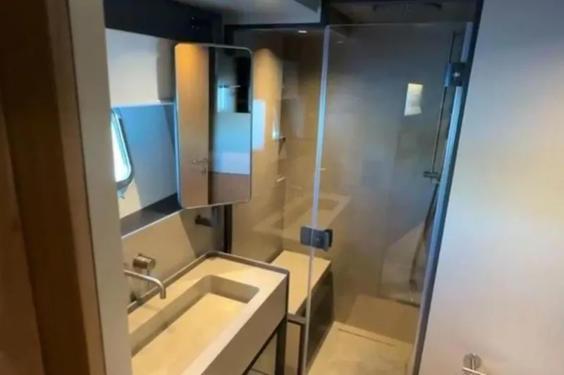  Yacht Photos Pics Modern bathroom interior in 2025 Bluegame BG74 yacht, featuring sleek design and glass shower.
