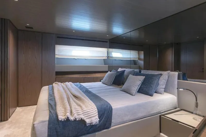  Yacht Photos Pics Luxurious bedroom interior of 2025 Bluegame BG74 yacht with modern design and cozy bedding.