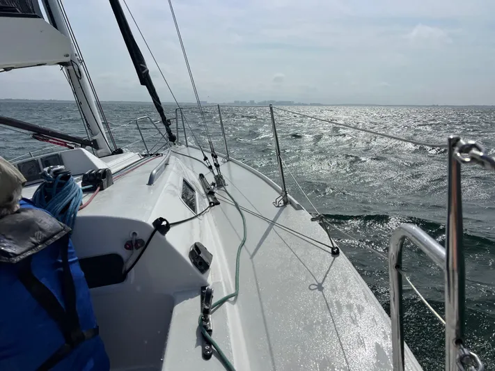 Encore Yacht Photos Pics Sailing on a 2011 J Boats J/95 yacht, gliding over shimmering waters.