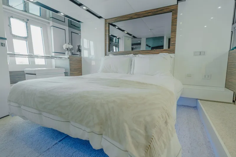 Scuderia Yacht Photos Pics Luxurious bedroom interior on 2010 Absolute 70 STY yacht, featuring elegant design and modern amenities.