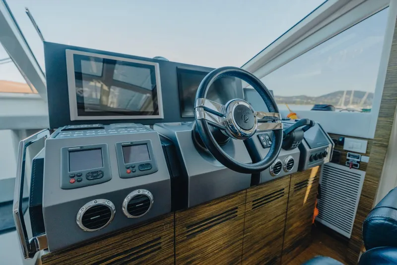 Scuderia Yacht Photos Pics Cockpit of 2010 Absolute 70 STY yacht with modern navigation controls and steering wheel.