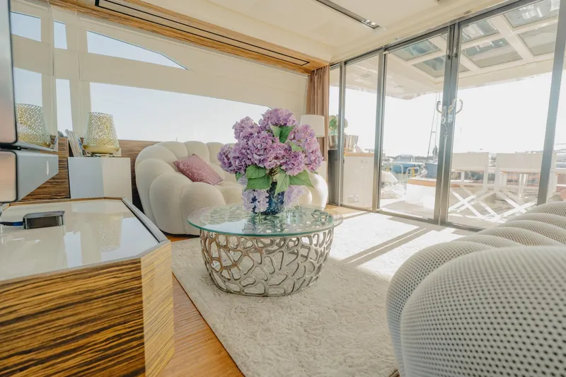 Scuderia Yacht Photos Pics Luxurious interior of 2010 Absolute 70 STY yacht with elegant decor and floral centerpiece.