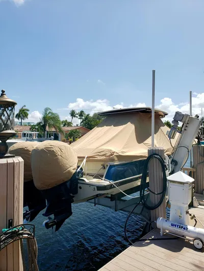  Yacht Photos Pics 2019 Chris-Craft Catalina 34 boat covered at a dock with palm trees in the background.