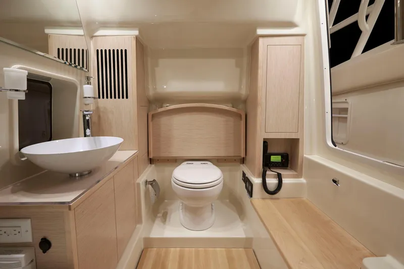  Yacht Photos Pics Luxurious bathroom interior of 2019 Chris-Craft Catalina 34 boat, featuring modern fixtures and wood accents.