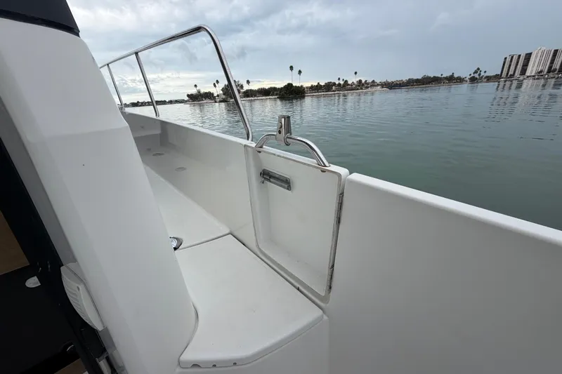  Yacht Photos Pics 2019 Jeanneau NC 895 boat deck with railing, overlooking calm waters and distant shoreline.