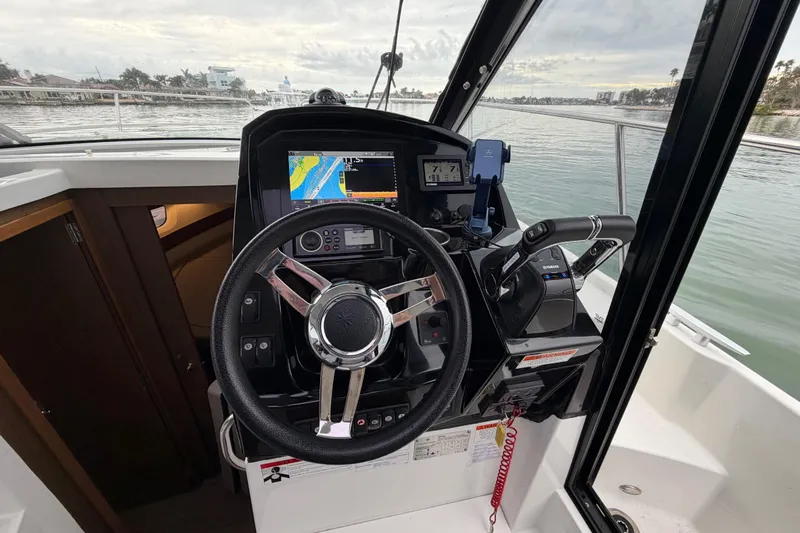  Yacht Photos Pics Helm of 2019 Jeanneau NC 895 boat with navigation equipment and steering wheel.