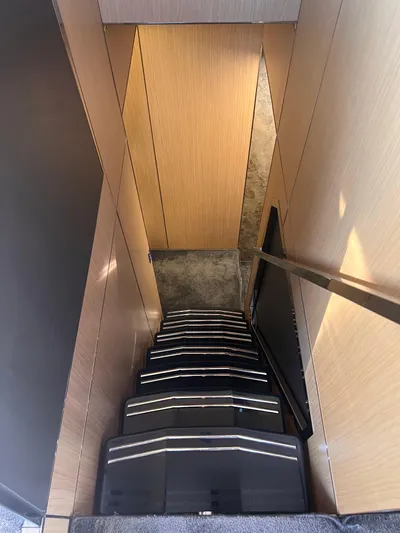  Yacht Photos Pics Staircase inside 2015 Arcadia Yachts A 85, featuring sleek wooden paneling.