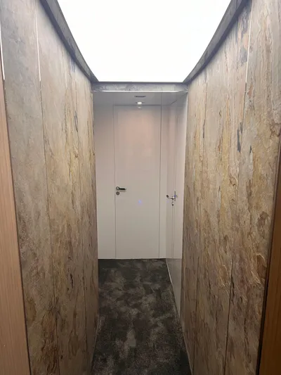  Yacht Photos Pics Narrow hallway inside 2015 Arcadia Yachts A 85, featuring modern design and lighting.